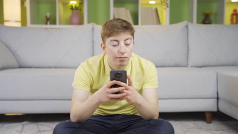 Young-man-browsing-phone,-using-social-media.